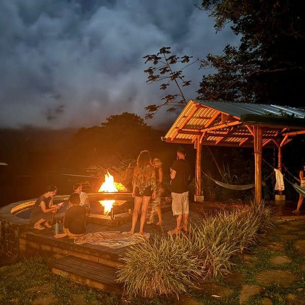 Pool and fire pit area at night under the jungle stars